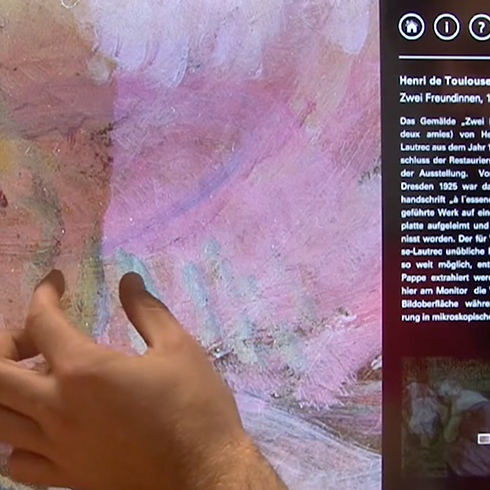 The photo shows how a user interacts in the zoomable information space and explores the artwork.